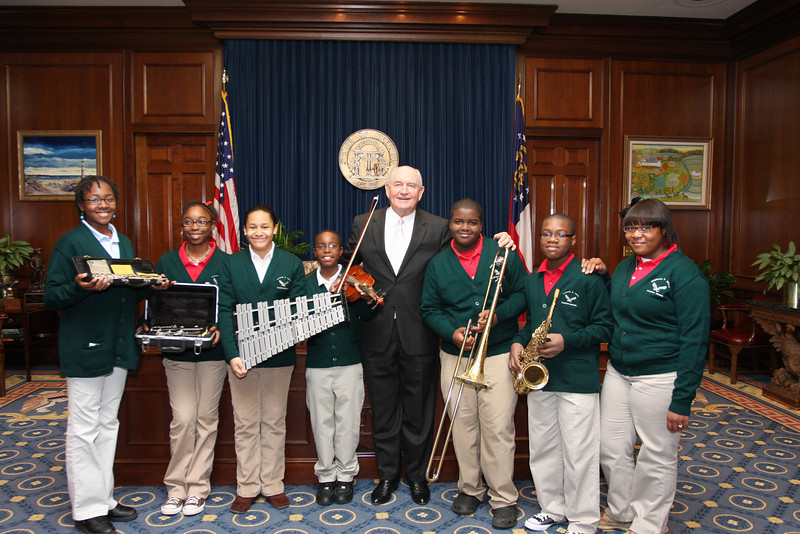 Governor Sonny Perdue poses with band students who have just received new musical instruments during a Gift Day donation.