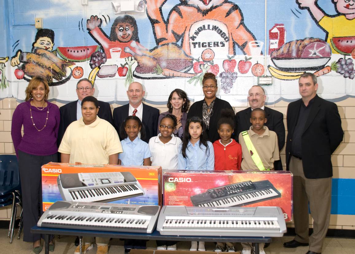 NPA Members stand with students of Knollwood Elementary School along with two new donated keyboards.